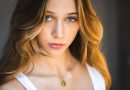 a beautiful young woman with blue eyes posing for a picture