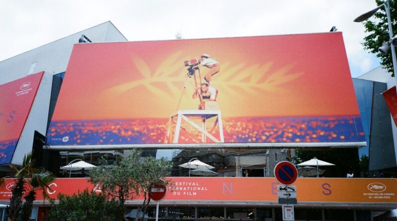 Large billboard at the Cannes Film Festival showcasing vibrant imagery.