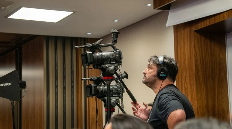 Cameraman operating professional video cameras during an indoor event. Perfect for media and broadcasting themes.