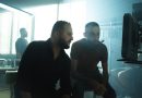 Film crew members collaborating in a Baghdad studio with dramatic lighting.