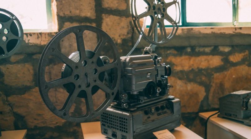 Classic vintage film projector displayed in a rustic indoor setting. Perfect for cinema enthusiasts.